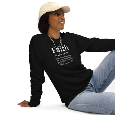Woman sitting on white floor wearing a black sweater that reads "Faith is like wi-fi it's invisible but it has the power to connect you to what you need. Hebrews 11:1"