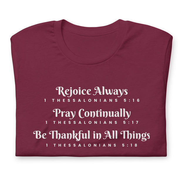 Folded maroon unisex t-shirt that has the scripture, 1 Thessalonians 5:16-5:18, Rejoice Always, Pray Continually, Be Thankful in All Things