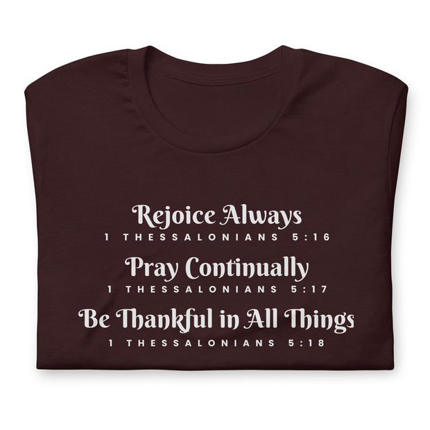 Folded dark brown unisex t-shirt that has the scripture, 1 Thessalonians 5:16-5:18, Rejoice Always, Pray Continually, Be Thankful in All Things