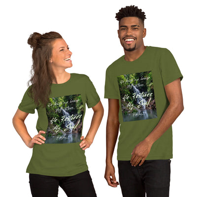 A couple wearing an olive Christian t-shirt that has a picture of a waterfall behind Psalm 23, He Restores my Soul scripture in white text.